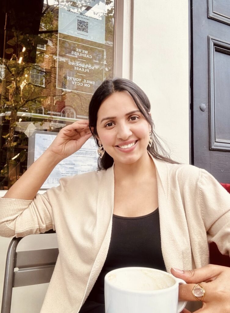 Happy girl sitting in an outdoor cafe at Piccadilly Circus, London