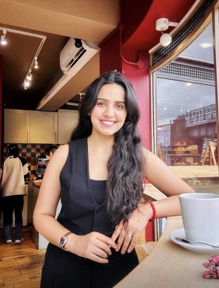 Girl in black standing by a cafe table