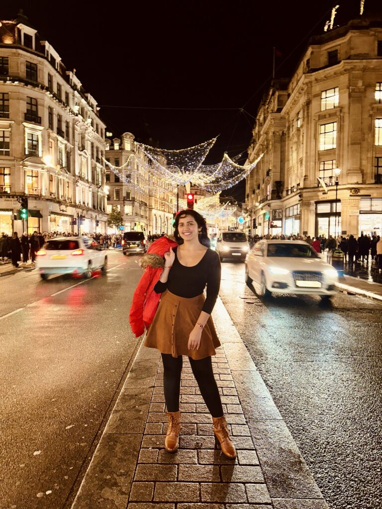 Girl at Oxford Street surrounded by Christmas Decorations